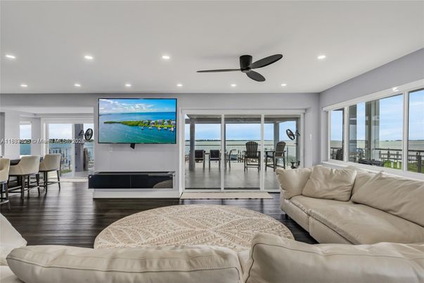 Dining room, Fireplace, Interior, Living room, Recessed Lighting, Water, Wood Texture Flooring