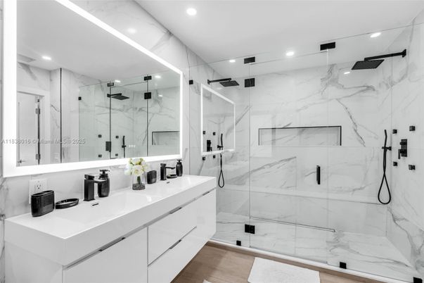 Bathroom, Dual Sink Vanities, Glass Shower, Interior, Marble Walls, Recessed Lighting, Wood Texture Flooring