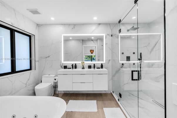 Bathroom, Dual Sink Vanities, Glass Shower, Interior, Marble Walls, Recessed Lighting, Wood Texture Flooring