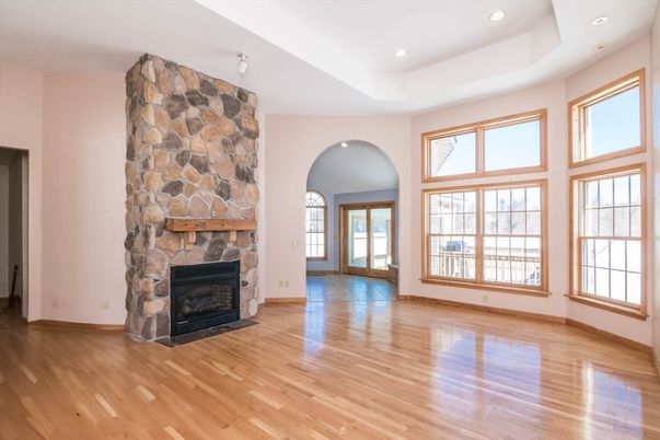 Empty room, Fireplace, Interior, Recessed Lighting, Stone Walls, Wood Texture Flooring