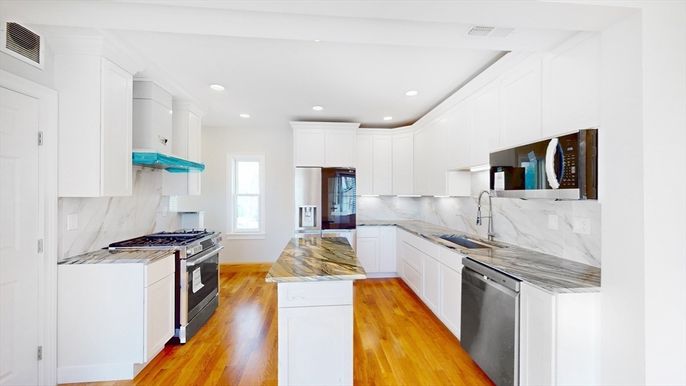 Interior, Kitchen, Marble Walls, Recessed Lighting, Stainless Steel Appliances, Wood Texture Flooring