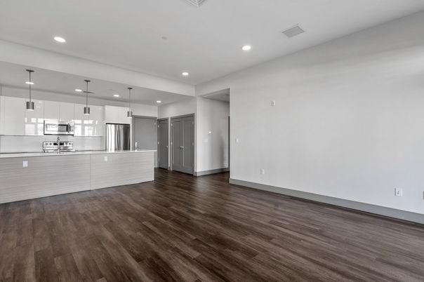 Empty room, Interior, Kitchen, Pendant Lights, Recessed Lighting, Stainless Steel Appliances, Wood Texture Flooring
