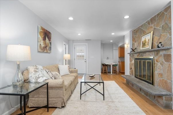 Fireplace, Interior, Living room, Recessed Lighting, Stone Walls, Wood Texture Flooring
