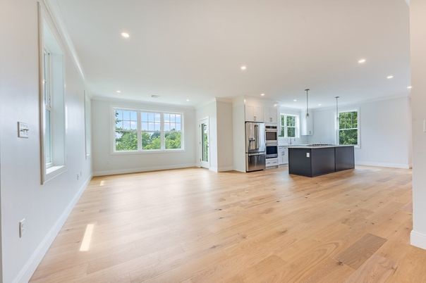 Empty room, Interior, Kitchen, Pendant Lights, Recessed Lighting, Stainless Steel Appliances, Wood Texture Flooring