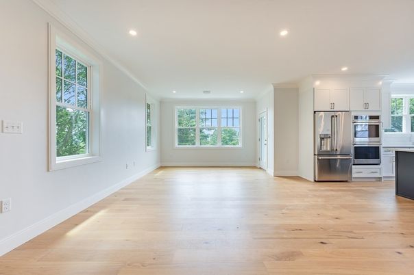 Empty room, Interior, Kitchen, Recessed Lighting, Stainless Steel Appliances, Wood Texture Flooring