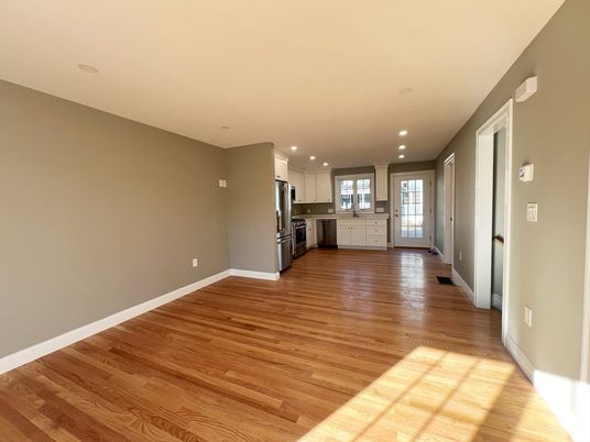 Empty room, Interior, Kitchen, Recessed Lighting, Stainless Steel Appliances, Wood Texture Flooring