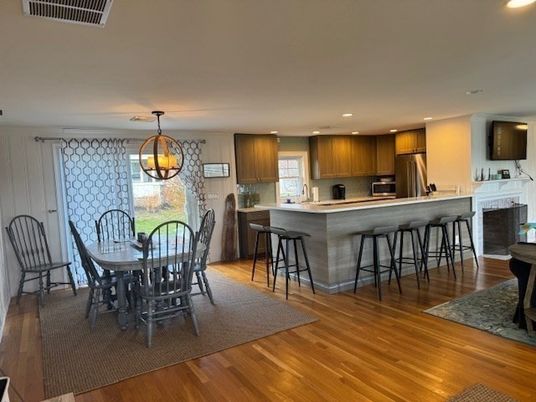 Chandelier, Dining room, Fireplace, Interior, Kitchen, Pendant Lights, Recessed Lighting, Stainless Steel Appliances, Wood Texture Flooring