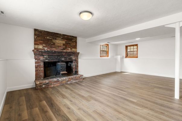 Empty room, Fireplace, Interior, Recessed Lighting, Stone Walls, Wood Texture Flooring