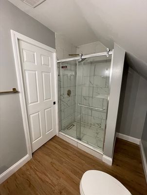 Bathroom, Glass Shower, Interior, Marble Walls, Wood Texture Flooring