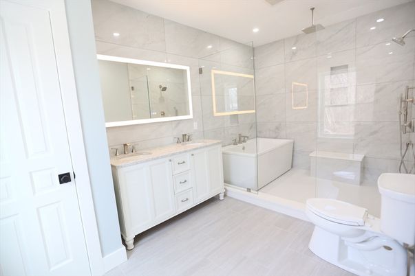 Bathroom, Dual Sink Vanities, Free Standing Baths, Glass Shower, Interior, Marble Walls, Recessed Lighting, Wood Texture Flooring