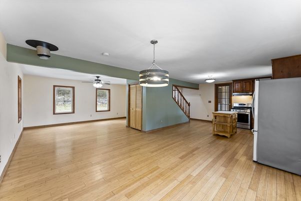 Empty room, Interior, Kitchen, Pendant Lights, Stainless Steel Appliances, Wood Texture Flooring