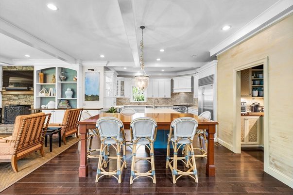 Dining room, Fireplace, Interior, Kitchen, Pendant Lights, Recessed Lighting, Stainless Steel Appliances, Stone Walls, Wood Texture Flooring