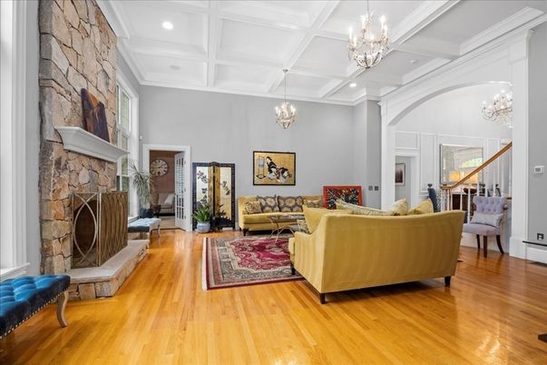 Chandelier, Fireplace, Interior, Living room, Recessed Lighting, Stone Walls, Wood Texture Flooring