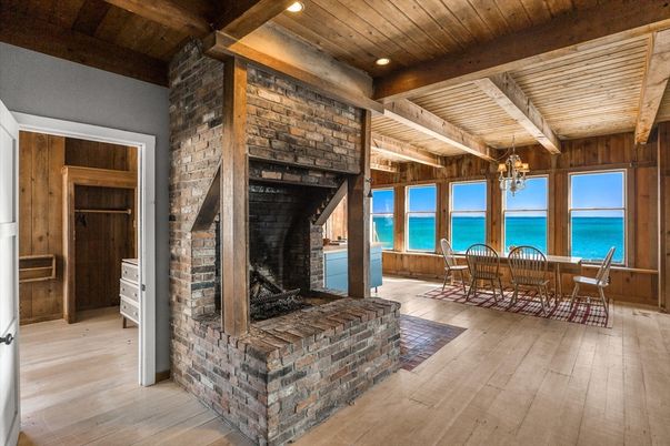 Chandelier, Dining room, Fireplace, Interior, Recessed Lighting, Stone Walls, Water, Wooden Beams, Wooden Ceilings, Wood Texture Flooring, Wooden Walls