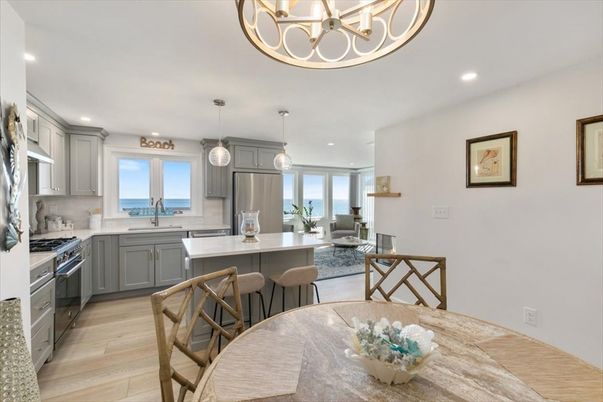 Chandelier, Dining room, Interior, Kitchen, Living room, Pendant Lights, Recessed Lighting, Stainless Steel Appliances, Water, Wood Texture Flooring
