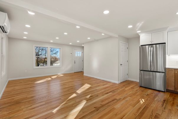 Empty room, Interior, Kitchen, Recessed Lighting, Stainless Steel Appliances, Wood Texture Flooring