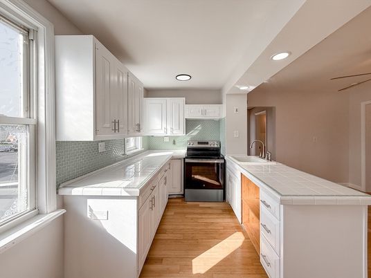 Interior, Kitchen, Recessed Lighting, Tile Countertops, Wood Texture Flooring