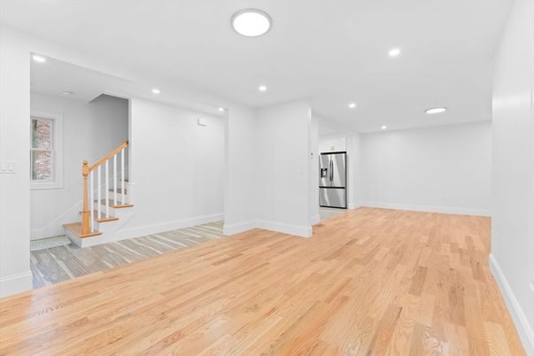 Empty room, Interior, Kitchen, Recessed Lighting, Stainless Steel Appliances, Wood Texture Flooring