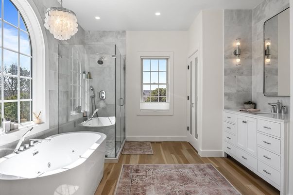 Bathroom, Chandelier, Dual Sink Vanities, Free Standing Baths, Glass Shower, Interior, Marble Walls, Recessed Lighting, Wood Texture Flooring