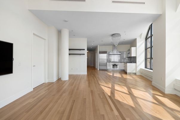 Empty room, Interior, Kitchen, Recessed Lighting, Stainless Steel Appliances, Wood Texture Flooring