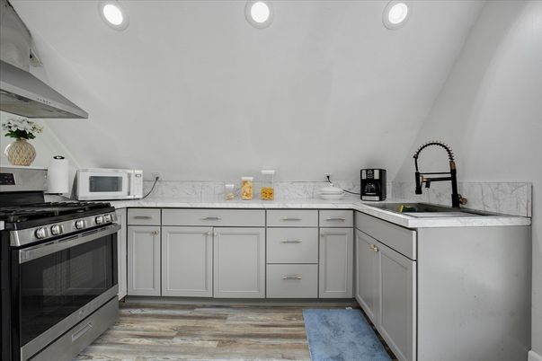 Interior, Kitchen, Marble Walls, Recessed Lighting, Stainless Steel Appliances, Wood Texture Flooring