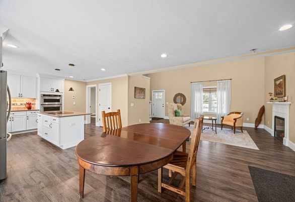 Dining room, Fireplace, Interior, Kitchen, Recessed Lighting, Stainless Steel Appliances, Wood Texture Flooring