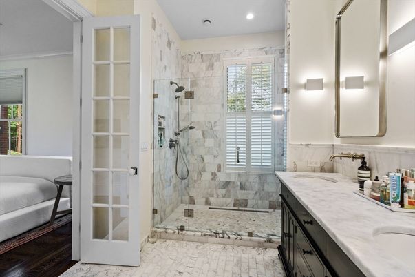 Bathroom, Dual Sink Vanities, Glass Shower, Interior, Marble Walls, Recessed Lighting, Wood Texture Flooring