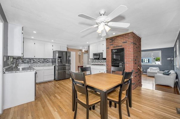 Dining room, Fireplace, Interior, Kitchen, Living room, Recessed Lighting, Stainless Steel Appliances, Stone Walls, Wood Texture Flooring