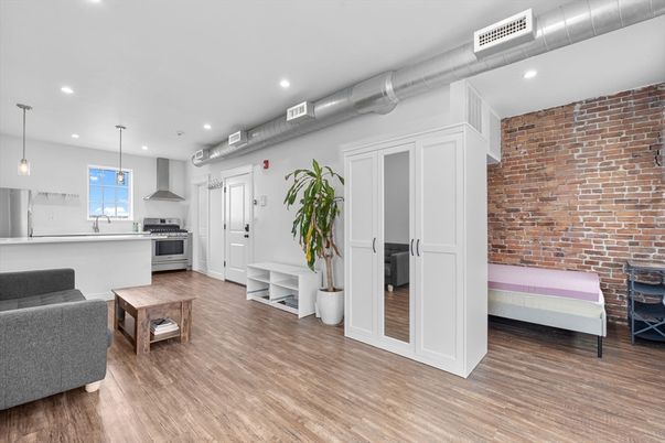 Interior, Kitchen, Pendant Lights, Recessed Lighting, Stainless Steel Appliances, Stone Walls, Wood Texture Flooring