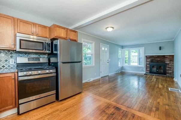 Empty room, Fireplace, Interior, Kitchen, Stainless Steel Appliances, Wood Texture Flooring