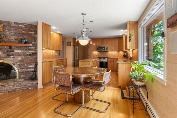 Dining room, Fireplace, Interior, Kitchen, Pendant Lights, Recessed Lighting, Stainless Steel Appliances, Stone Walls, Wood Texture Flooring