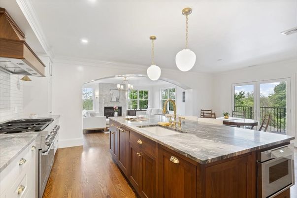 Chandelier, Dining room, Fireplace, Interior, Kitchen, Living room, Pendant Lights, Recessed Lighting, Stainless Steel Appliances, Wood Texture Flooring
