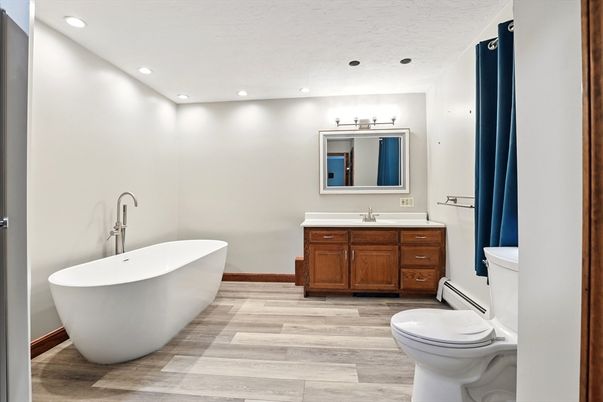 Bathroom, Dual Sink Vanities, Free Standing Baths, Interior, Recessed Lighting, Wood Texture Flooring