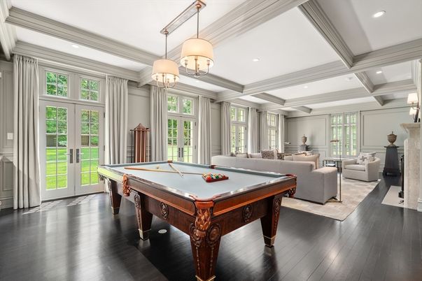 Billiard Table, Chandelier, Fireplace, Game Room, Interior, Living room, Pendant Lights, Recessed Lighting, Wood Texture Flooring
