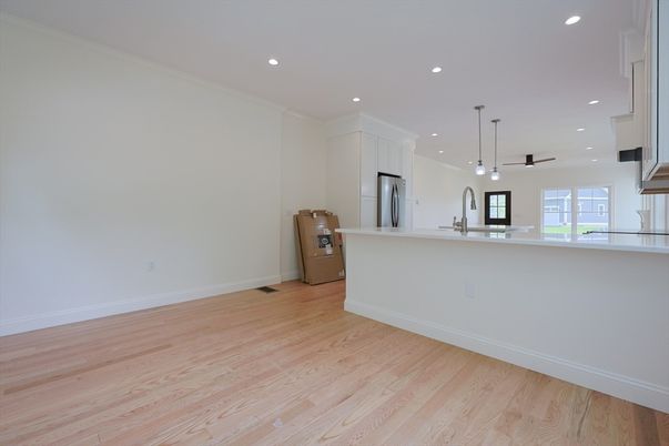 Empty room, Interior, Kitchen, Pendant Lights, Recessed Lighting, Stainless Steel Appliances, Wood Texture Flooring