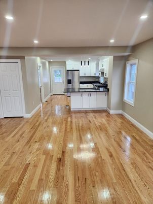 Empty room, Interior, Kitchen, Recessed Lighting, Stainless Steel Appliances, Wood Texture Flooring