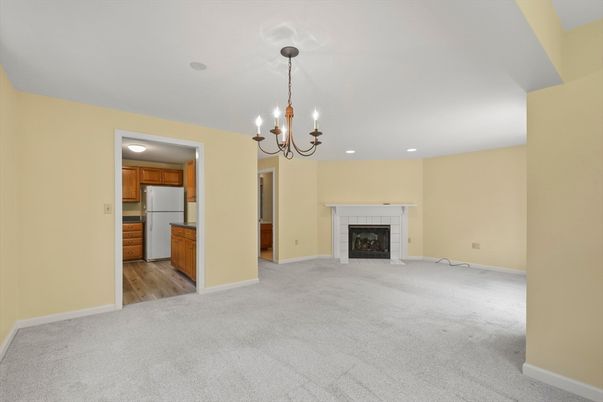 Chandelier, Empty room, Fireplace, Interior, Kitchen, Recessed Lighting, Wood Texture Flooring