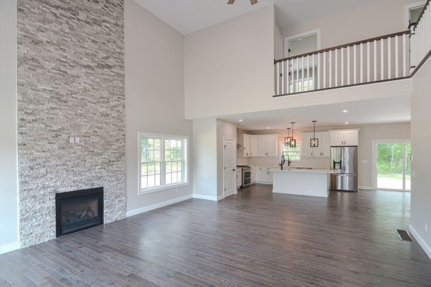 Fireplace, Interior, Kitchen, Pendant Lights, Recessed Lighting, Stainless Steel Appliances, Stone Walls, Wood Texture Flooring