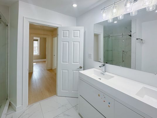 Bathroom, Dual Sink Vanities, Glass Shower, Interior, Marble, Recessed Lighting, Wood Texture Flooring