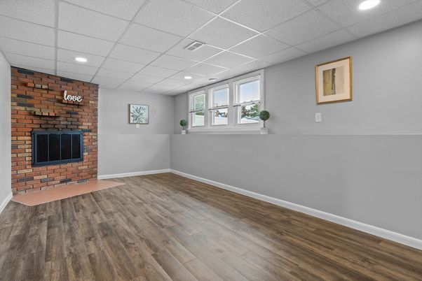 Empty room, Fireplace, Interior, Recessed Lighting, Stone Walls, Wood Texture Flooring