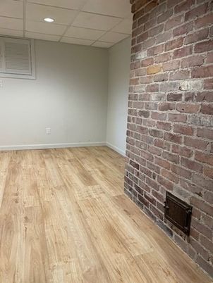 Empty room, Fireplace, Interior, Recessed Lighting, Stone Walls, Wood Texture Flooring