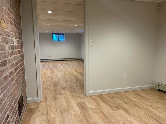 Empty room, Fireplace, Interior, Recessed Lighting, Stone Walls, Wood Texture Flooring