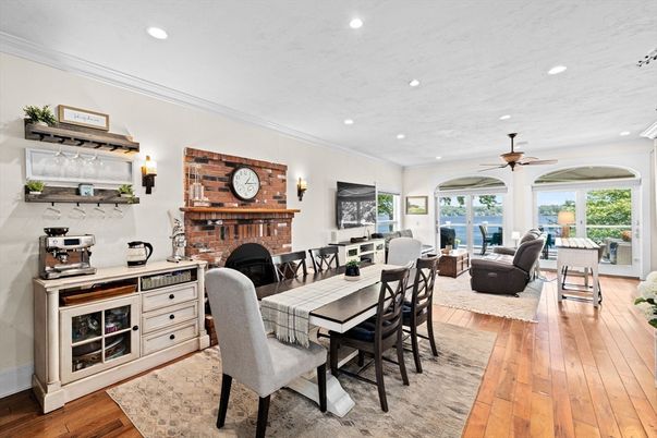Dining room, Fireplace, Interior, Living room, Recessed Lighting, Stone Walls, Wood Texture Flooring