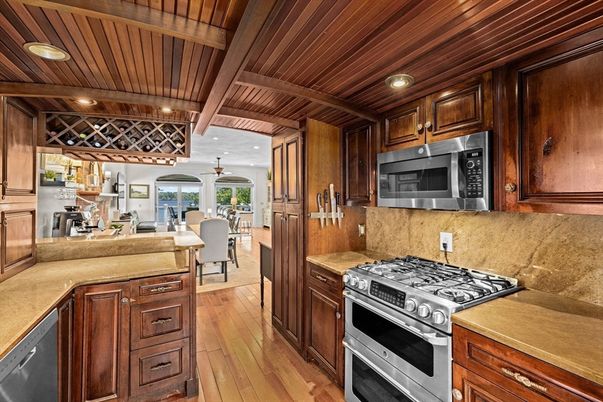 Chandelier, Dining room, Interior, Kitchen, Living room, Recessed Lighting, Stainless Steel Appliances, Wooden Beams, Wooden Ceilings, Wood Texture Flooring