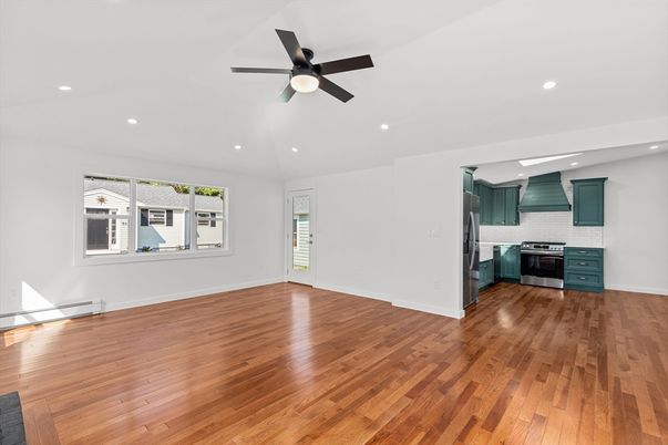 Empty room, Interior, Kitchen, Recessed Lighting, Stainless Steel Appliances, Wood Texture Flooring
