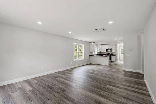Empty room, Interior, Kitchen, Recessed Lighting, Stainless Steel Appliances, Wood Texture Flooring