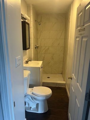 Bathroom, Glass Shower, Interior, Marble Walls, Wood Texture Flooring