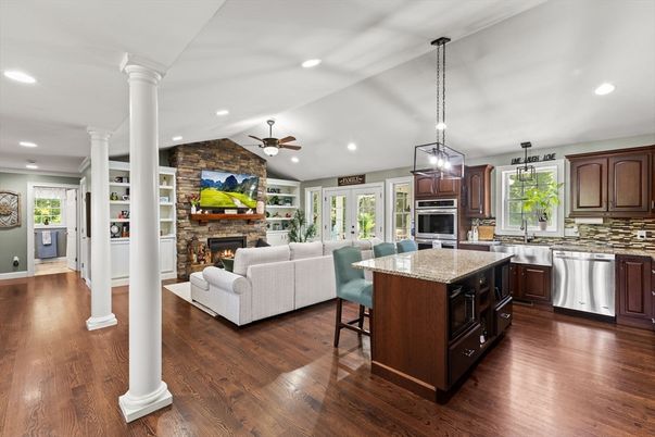 Fireplace, Interior, Kitchen, Living room, Pendant Lights, Recessed Lighting, Stainless Steel Appliances, Stone Walls, Wood Texture Flooring