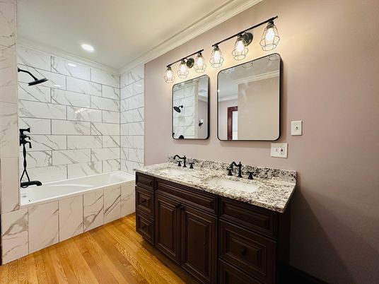 Bathroom, Dual Sink Vanities, Interior, Marble Walls, Recessed Lighting, Wood Texture Flooring