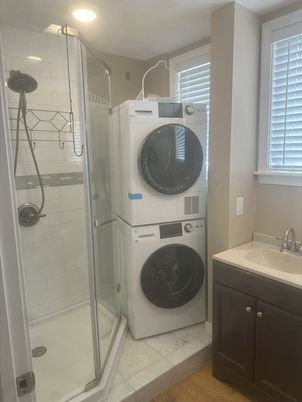 Bathroom, Glass Shower, Interior, Recessed Lighting, Utility Closets, Washer, Wood Texture Flooring